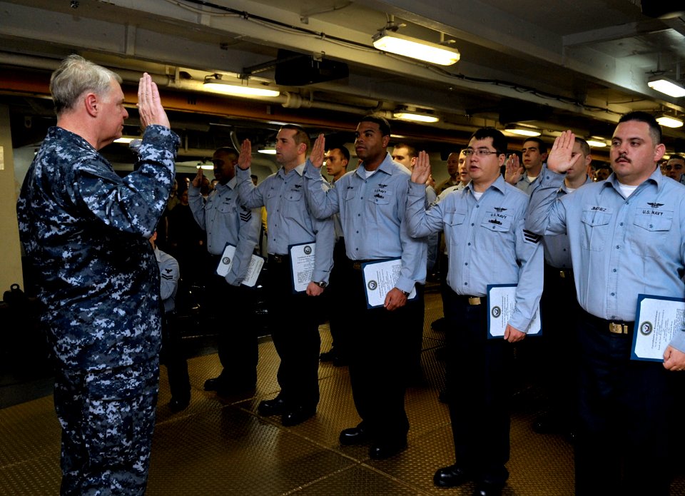 US Navy 100106-N-8273J-078 Chief of Naval Operations (CNO) Adm. Gary Roughead administers the oath of reenlistment to 25 Sailors during a ceremony aboard the aircraft carrier USS Nimitz (CVN 68)