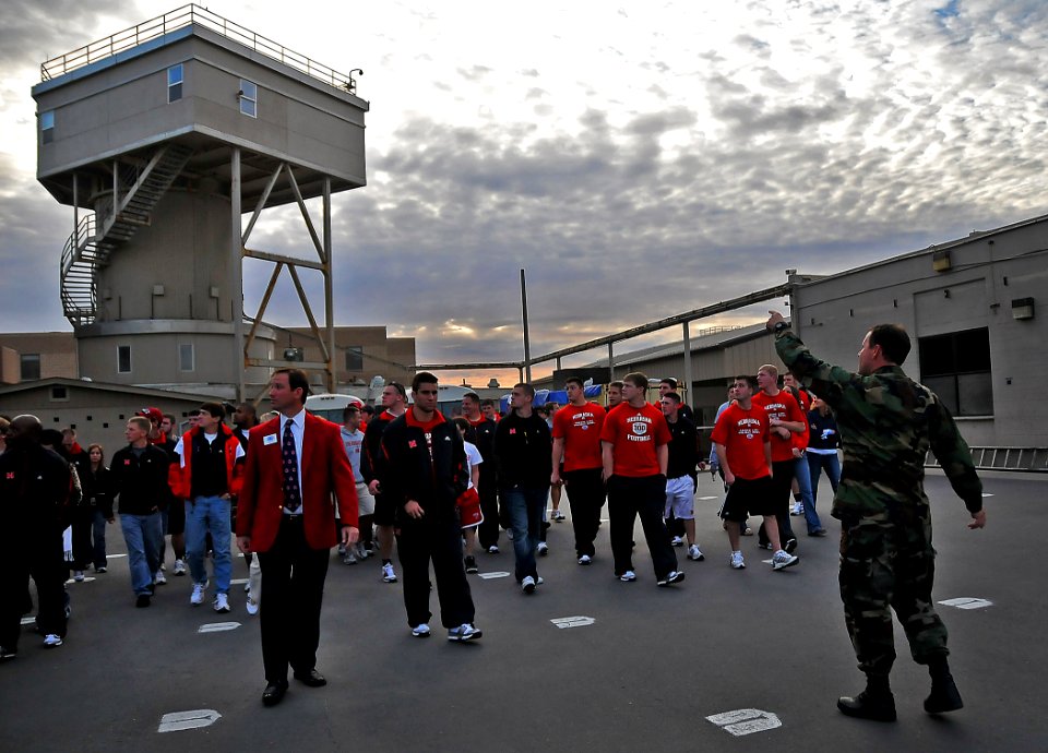 US Navy 091228-N-4774B-075 Athletes and staff of the University of Nebraska football team pass by a five-story dive tank during a guided tour of Naval Special Warfare Center, Navy SEALs training facility