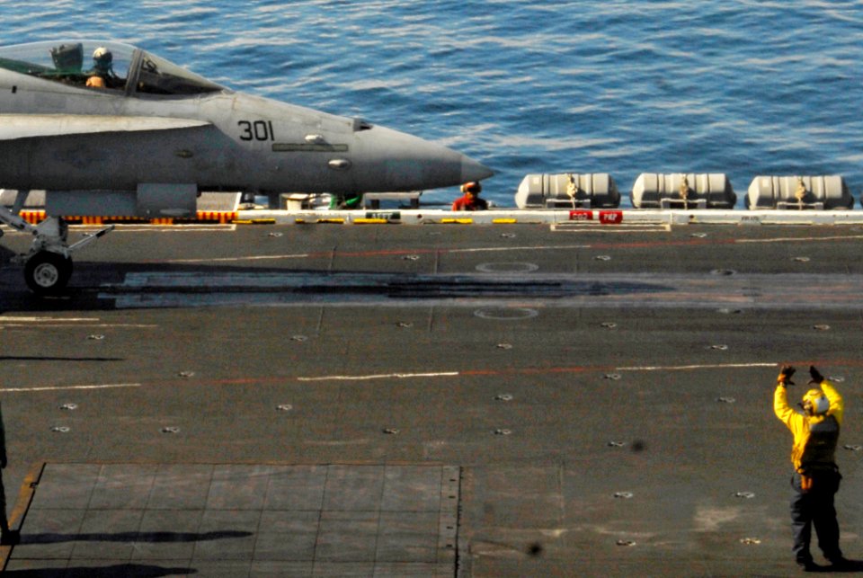US Navy 100104-N-3327M-074 Sailors aboard the aircraft carrier USS Nimitz (CVN 68) prepare to launch an F-A-18C Hornet strike fighter assigned to the Warhawks of Strike Fighter Squadron (VFA) 97