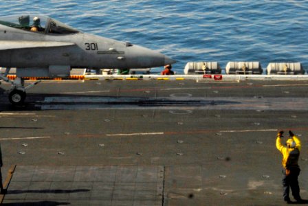 US Navy 100104-N-3327M-074 Sailors aboard the aircraft carrier USS Nimitz (CVN 68) prepare to launch an F-A-18C Hornet strike fighter assigned to the Warhawks of Strike Fighter Squadron (VFA) 97 photo