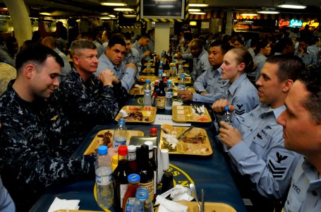 US Navy 100106-N-8273J-268 Master Chief Petty Officer of the Navy (MCPON) Rick West, middle left, dines on the mess decks with Sailors aboard the aircraft carrier USS Nimitz (CVN 68)