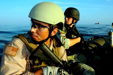 US Navy 100101-N-1291E-140 Ensign Victor Nitividad and Cryptologic Technician 3rd Class Matthew Hunter approaches a dhow in the Gulf of Aden