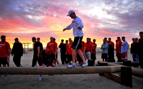 US Navy 091228-N-4774B-167 Athletes and staff of the University of Nebraska football team attempt the balance beam portion of an obstacle course during a guided tour of the Naval Special Warfare Center, Navy SEALs training faci