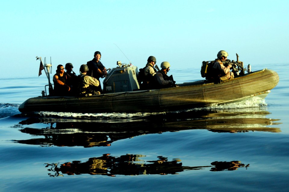 US Navy 100101-N-1291E-147 Members of the visit, board, search and seizure team and the Coast Guard's Maritime Safety and Security Team approach a dhow in a rigid hull inflatable boat