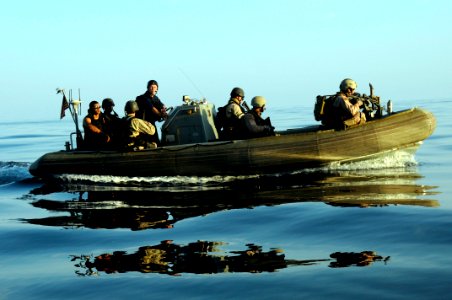 US Navy 100101-N-1291E-147 Members of the visit, board, search and seizure team and the Coast Guard's Maritime Safety and Security Team approach a dhow in a rigid hull inflatable boat