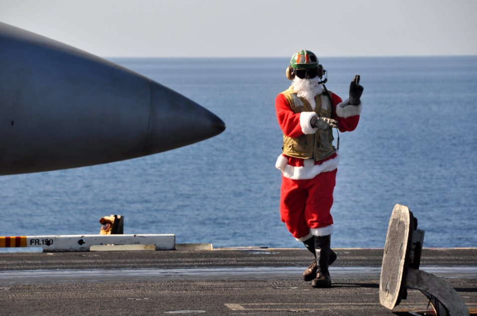 US Navy 091225-N-8421M-103 t. Jon Sunderland dresses in a Santa suite while directing aircraft operations aboard the aircraft carrier USS Nimitz (CVN 68) Christmas Day