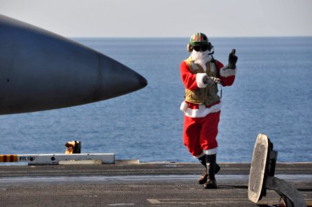 US Navy 091225-N-8421M-103 t. Jon Sunderland dresses in a Santa suite while directing aircraft operations aboard the aircraft carrier USS Nimitz (CVN 68) Christmas Day