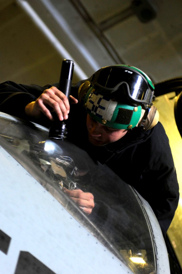 US Navy 100104-N-6604E-154 Aviation Electrician's Mate Airman Matthew Gould performs a maintenance check on an E-A-6B Prowler