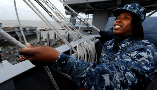 US Navy 100112-N-2953W-001 Quartermaster 2nd Class Candice Stone hoists a signal flag as the Nimitz-class aircraft carrier USS Carl Vinson (CVN 70) prepares to get underway