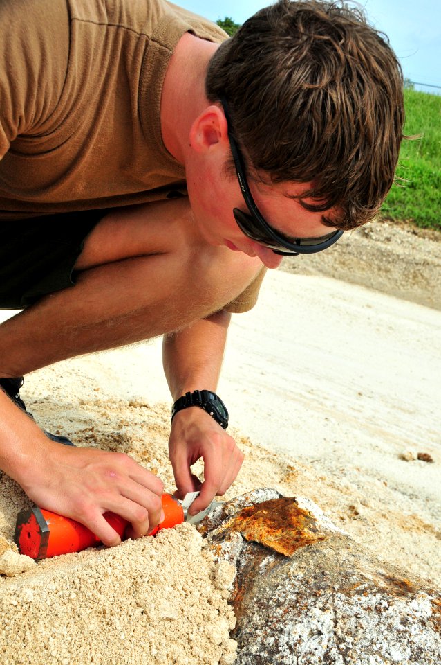 US Navy 091909-N-5469W-022 Explosive Ordnance Disposal Technician 2nd Class Dan Christenson aligns an MK-2 .50 caliber de-armer at the fuse assembly of a 500 pound World War II era bomb