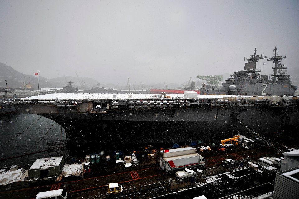 US Navy 100113-N-0807W-020 The amphibious assault ship USS Essex (LHD 2) rests in her berth at Fleet Activities Sasebo as snow falls over Japan's Kyushu region