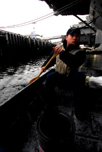 US Navy 100106-N-2475A-262 Boatswain's Mate 1st Class Pete Johnson, from Stanwood, Wash., paddles a punt boat alongside the Nimitz-class aircraft carrier USS John C. Stennis (CVN 74)