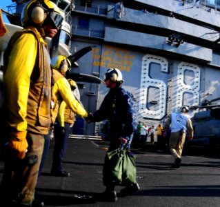 US Navy 100106-N-9760Z-086 Master Chief Petty Officer of the Navy (MCPON) Richard West shakes hands with Sailors