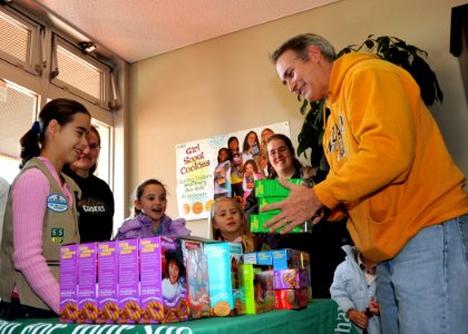 US Navy 100109-N-4031K-050 Capt. Eric Gardner buys boxes of Girl Scout cookies from Girl Scouts at the commissary at Naval Air Facility Atsugi