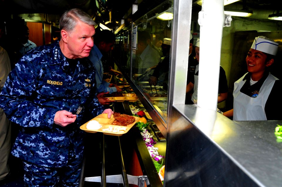 US Navy 100106-N-9760Z-053(1) Chief of Naval Operations (CNO) Adm. Gary Roughead goes through the mess deck line before having dinner with Sailors aboard USS Nimitz (CVN 68)