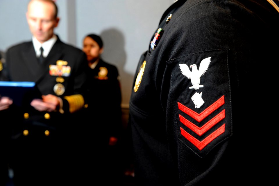 US Navy 100112-N-0555B-733 Vice Chief of Naval Operations (VCNO) Adm. Jonathan W. Greenert reads a citation meritoriously promoting Personnel Specialist 1st Class Tyrone Davis