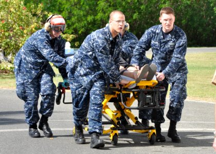 US Navy 100113-N-8241M-103 Navy hospital staff members rush an American U.S. Embassy worker into the U.S. Naval Hospital at Guantanamo Bay, Cuba