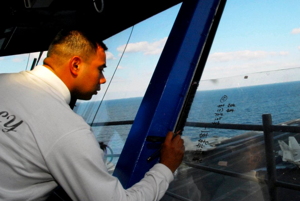 US Navy 100107-N-3327M-057 Aviation Boatswain's Mate (Handling) Joshua Garcia logs aircraft landings from primary flight control