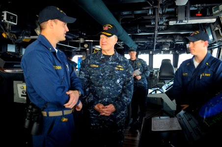 US Navy 100106-N-8273J-122 Chief of Naval Operations (CNO) Adm. Gary Roughead, middle, visits with Sailors on the bridge of the guided-missile destroyer USS Sampson (DDG 102) photo