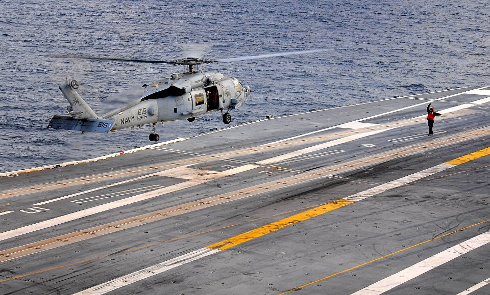 US Navy 100113-N-4774B-906 A flight deck crew member directs a SH-60F Sea Hawk assigned to the Red Lions of Helicopter Squadron (HS) 15, during flight operations aboard the Nimitz-class aircraft carrier USS Carl Vinson (CVN 70)