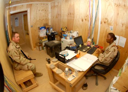 US Navy 100106-N-9564W-021 Chief Navy Counselor Surgann Coker-Bello, right, from Florence, S.C., counsels Builder 2nd Class Scott Bryant