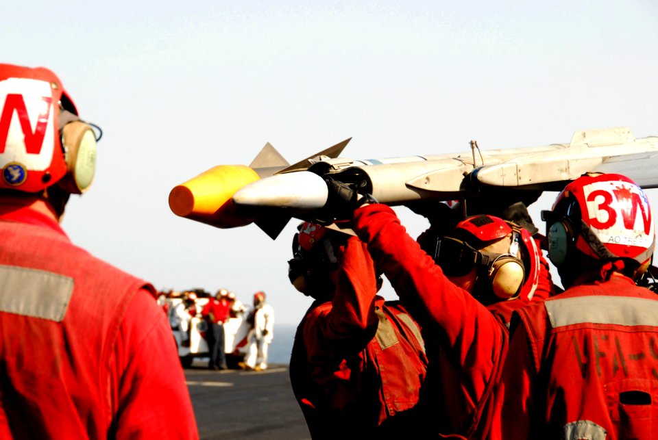 US Navy 100109-N-3327M-116 Aviation Ordnancemen upload ordnance onto an F-A-18C Hornet