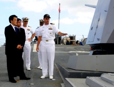 US Navy 100111-N-7498L-022 Cmdr. Mike McCartney gives a tour of the ship's forecastle to Katsuya Okada