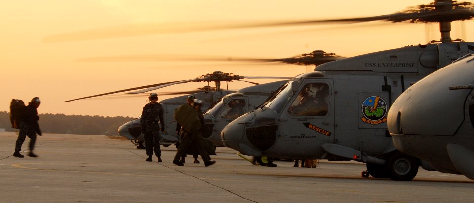 US Navy 100113-N-8590G-006 Sailors assigned to Helicopter Anti-Submarine Squadron (HS) 7 board SH-60 Sea Hawk helicopters at Naval Air Station Jacksonville as naval air crewmen prepare for departure to the aircraft carrier USS