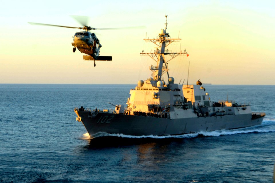 US Navy 100114-N-3038W-327 The guided-missile destroyer USS Sampson (DDG 102) and an MH-60S Sea Hawk helicopter assigned to the Wildcards of Helicopter Sea Combat Squadron (HSC) 23