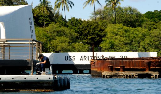 US Navy 100113-N-7498L-253 Logistics Specialist Seaman Fawn Thayer paints the deck leading to the USS Arizona Memorial