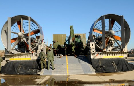 US Navy 100114-N-5787K-002 Seabees assigned to Amphibious Construction Battalion (ACB) 2 load vehicles and equipment onto landing craft air cushion vehicles to support Operation Unified Response