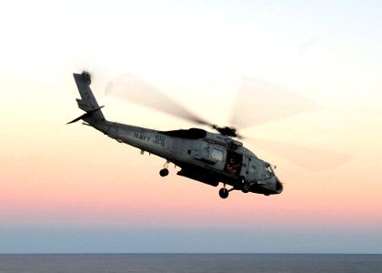 US Navy 100116-N-2953W-096 An SH-60S Sea Hawk helicopter flies from USS Carl Vinson (CVN 70) to transport volunteers to Haiti