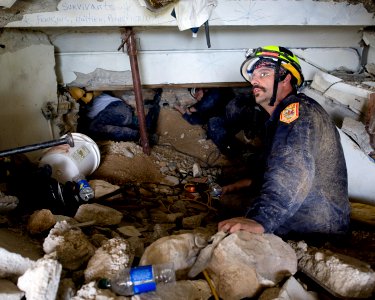 US Navy 100114-N-6266K-020 Members of Fairfax County Urban Search and Rescue conduct a rescue operation in a collapsed section of the Hotel Montana in Port-au-Prince, Haiti during a search for survivors of a 7.0 magnitude earth