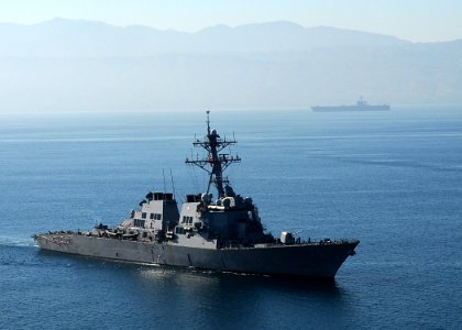 US Navy 100115-N-6247V-596 The guided-missile destroyer USS Higgins (DDG 76), foreground, and Nimitz-class aircraft carrier USS Carl Vinson (CVN 70) arrive off the coast of Haiti photo