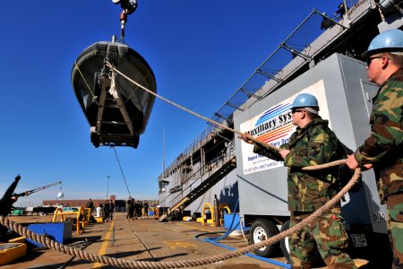 US Navy 100114-N-4267W-049 Sailors load a Navy security patrol boat before deploying to Haiti to assist with humanitarian relief efforts