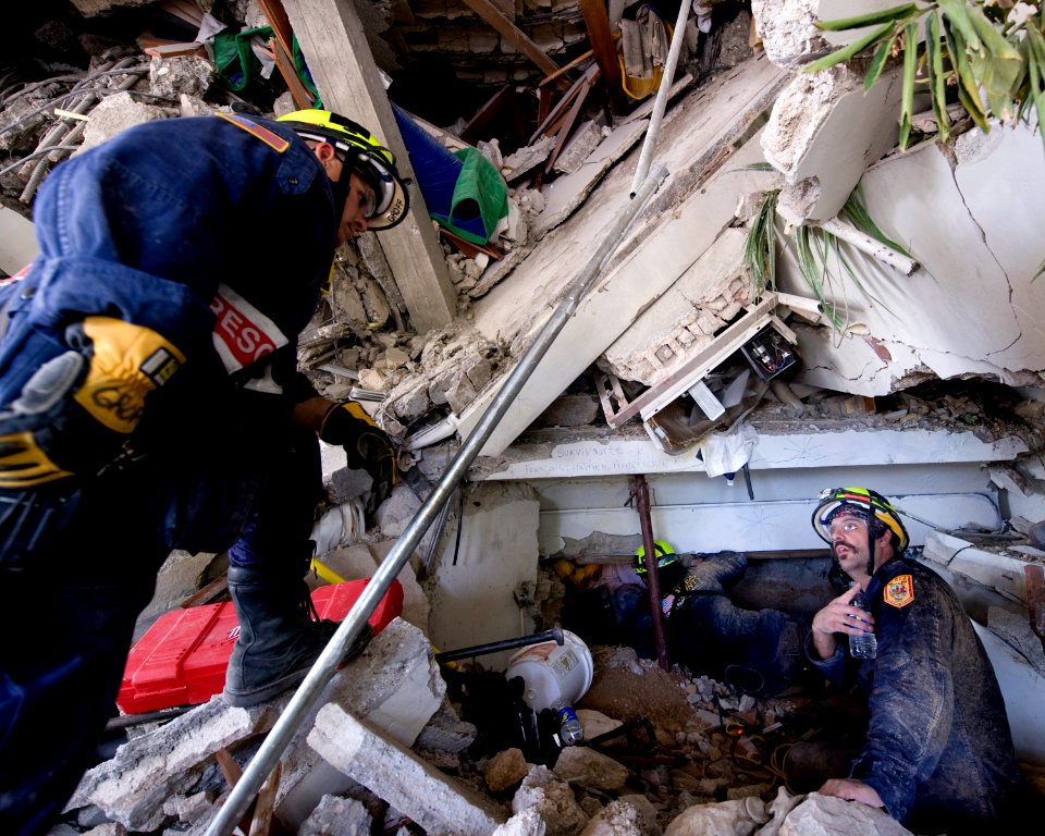 US Navy 100114-N-6266K-033 Members of Fairfax County Urban Search and Rescue conduct a rescue operation in a collapsed section of the Hotel Montana in Port-au-Prince, Haiti during a search for survivors of a 7.0 magnitude earth