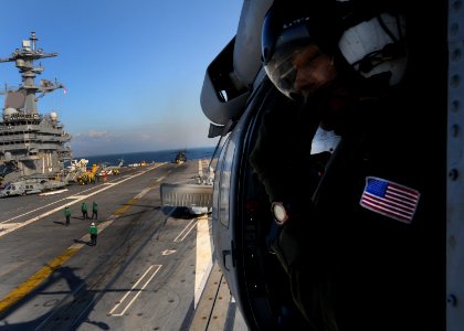 US Navy 100115-N-8878B-186 A Naval Air Crewman from the Nimitz-Class aircraft carrier USS Carl Vinson (CVN 70) returns to USS Carl Vinson (CVN 70) after delivering supplies to the Coast Guard Cutter Mohawk (WMEC 913) off the co