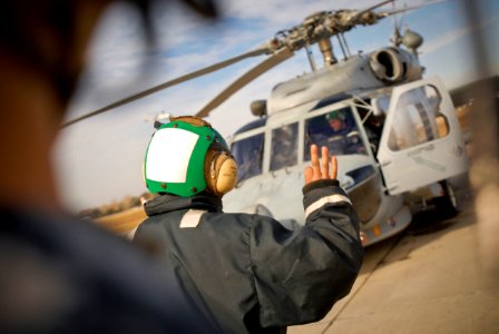 US Navy 100114-N-8590G-005 Sailors assists air crewmen with preflight checks at Naval Station Mayport