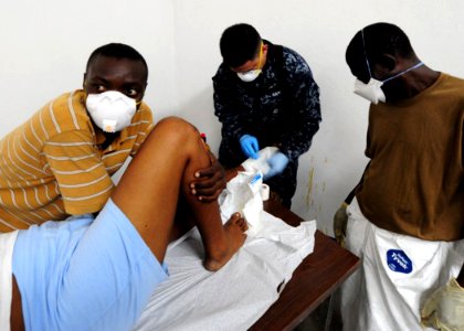 US Navy 100116-N-2953W-268 A U.S. Navy Hospital Corpsman treats an earthquake victim at Killick Haitian Coast Guard Base Clinic