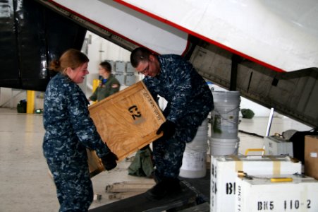 US Navy 100114-N-9402B-003 Sailors load boxes onto a C-2A Greyhound transport aircraft headed for Naval Station Guantanamo Bay, Cuba