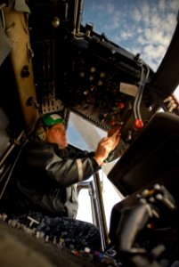 US Navy 100114-N-8590G-002 Aviation Electricians Mate 1st Class Ihosvani A. Diaz, assigned to Helicopter Anti-Submarine Squadron Light (HSL) 46, performs maintenance as naval air crewmen conduct preflight inspections