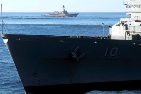 US Navy 100114-N-3038W-867 The guided-missile destroyer USS Sampson (DDG 102) cruises away from the Military Sealift Command fast combat support ship USNS Bridge (T-AOE 10)