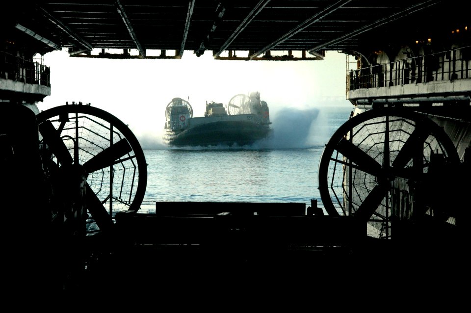 US Navy 100114-N-9806M-069 A landing craft air cushion approaches USS Bataan (LHD 5) as it prepares to depart Naval Station Norfolk to provide humanitarian assistance in the aftermath of a 7.0 magnitude earthquake near Port-au