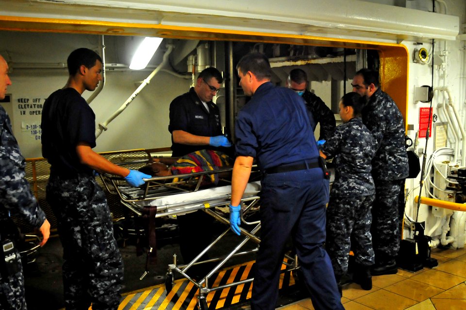 US Navy 100116-N-4774B-916 Aboard USS Carl Vinson (CVN 70) medical team members transport an injured Haitian male for treatment aboard the nuclear-powered aircraft carrier