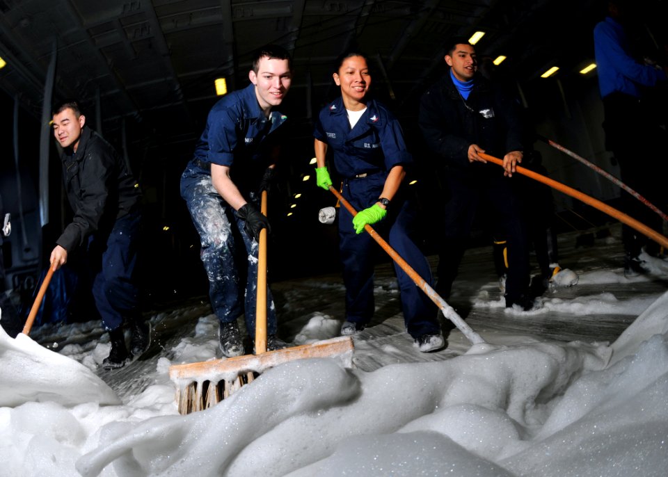 US Navy 100115-N-1261P-029 Sailors scrub the hangar bay for an aqueous film forming foam (AFFF) testing wash down aboard the aircraft carrier USS Abraham Lincoln (CVN 72)
