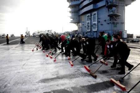 US Navy 100116-N-6604E-054 Sailors participate in a scrubbing exercise on the flight deck aboard the aircraft carrier USS Dwight D. Eisenhower (CVN 69)