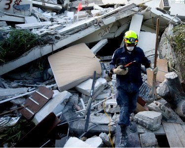 US Navy 100114-N-6266K-090 Members of Fairfax County Urban Search and Rescue conduct a rescue operation in a collapsed section of the Hotel Montana in Port-au-Prince, Haiti during a search for survivors of a 7.0 magnitude earth