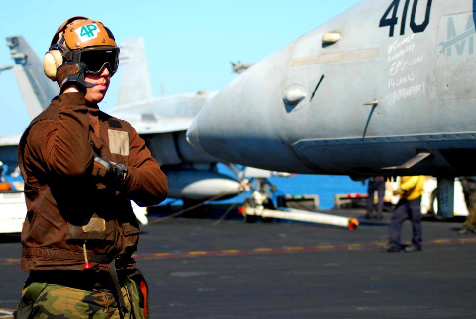 US Navy 100116-N-3589B-116 Aviation Boatswain's Mate (Equipment) Airman Brandon Young conducts pre-flight checkups on an F-A-18C Hornet assigned to the Sidewinders