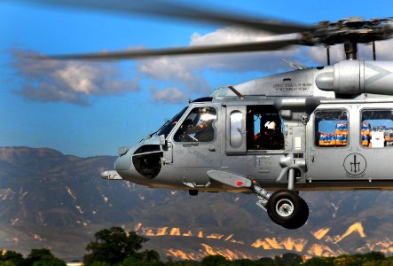 US Navy 100115-N-4774B-969 A SH-60F Sea Hawk helicopter assigned to the Red Lions of Helicopter Anti-Submarine Squadron (HS) 15, delivers water and supplies to Haiti as part of rescue and relief efforts