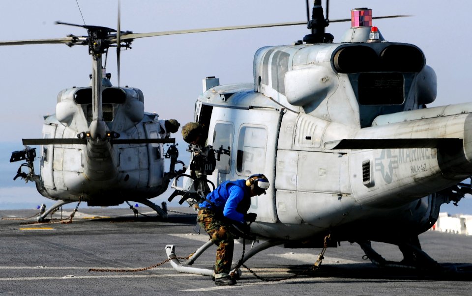 US Navy 100116-N-5345W-012 A Sailor ties down a UH-1N Huey from the Sabers of Marine Light Attack Helicopter Squadron (HMLA) 467 aboard the multi-purpose amphibious assault ship USS Bataan (LHD 5)